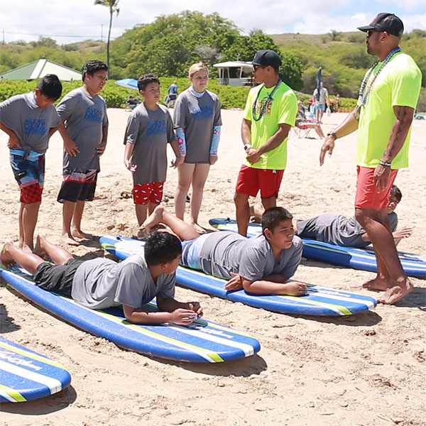 Students learn water rescue techniques with paddle boards